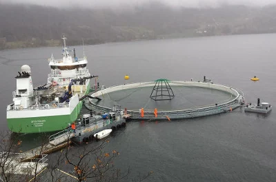 Aquaculture with supply ship in the fjord