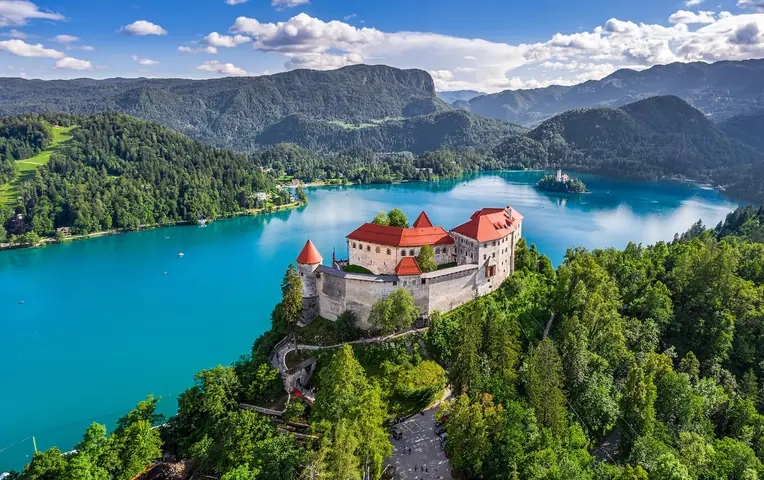 Bled Castle above Lake Bled, with the island church and the Julian Alps