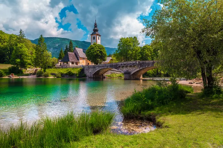 Church of St John the Baptist and the stone bridge at Lake Bohinj