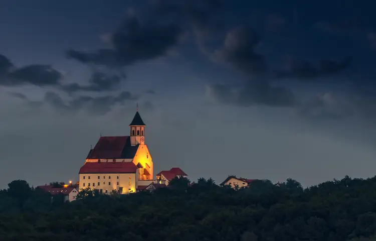 Basilica of Ptujska Gora lit up at dusk