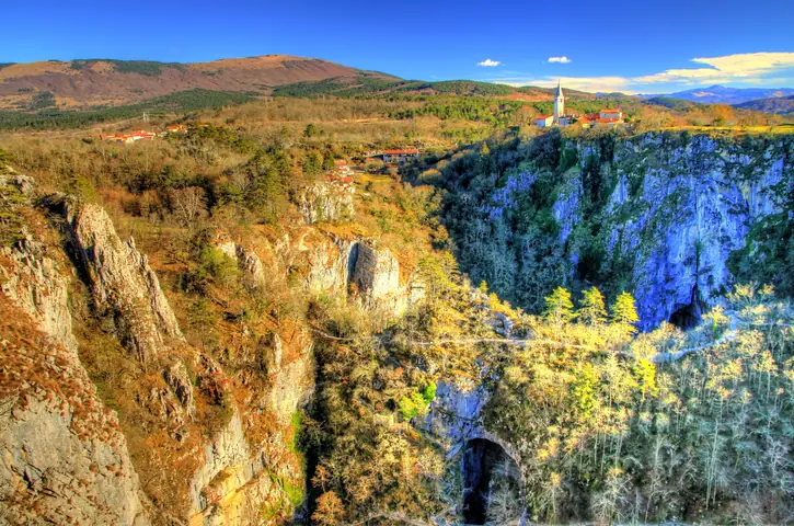 Deep sinkhole and limestone cliffs in the Karst
